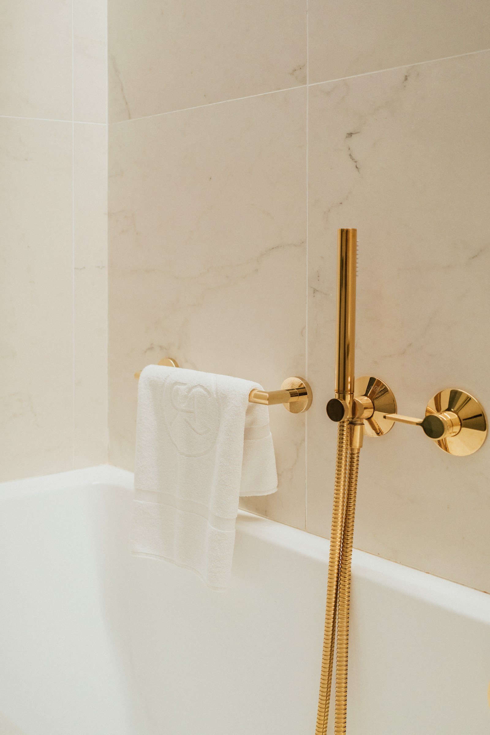 Luxury hotel bathroom with white hospitality towels — private label sourcing by Blue Lagoun