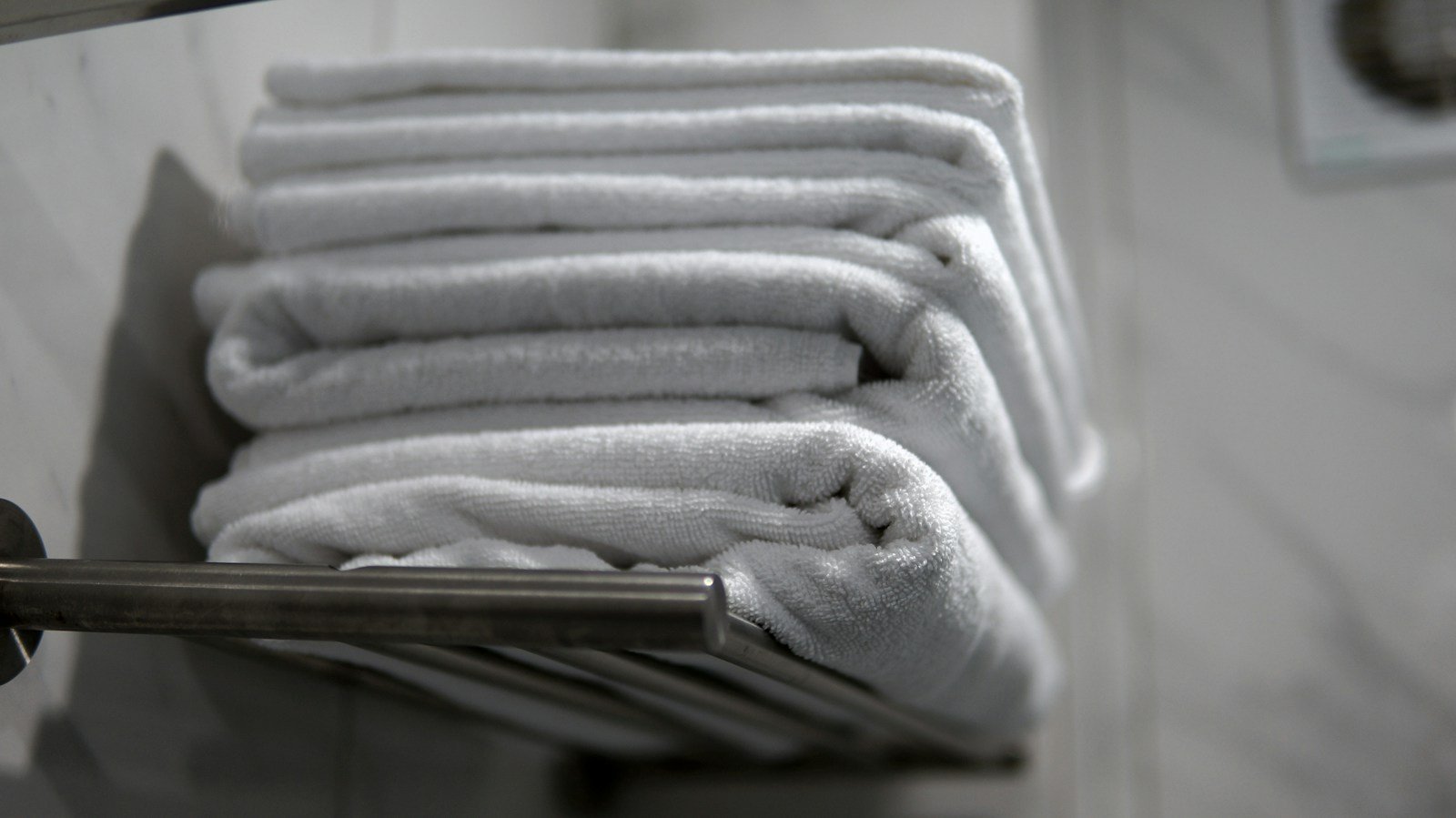 Premium white hotel towels folded and arranged in a luxury hospitality setting